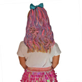 Girl wearing hot pink, teal, and light pink hair extensions with bow