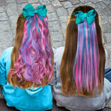 Girls wearing straight and wavy pink and teal hair extensions with teal bows
